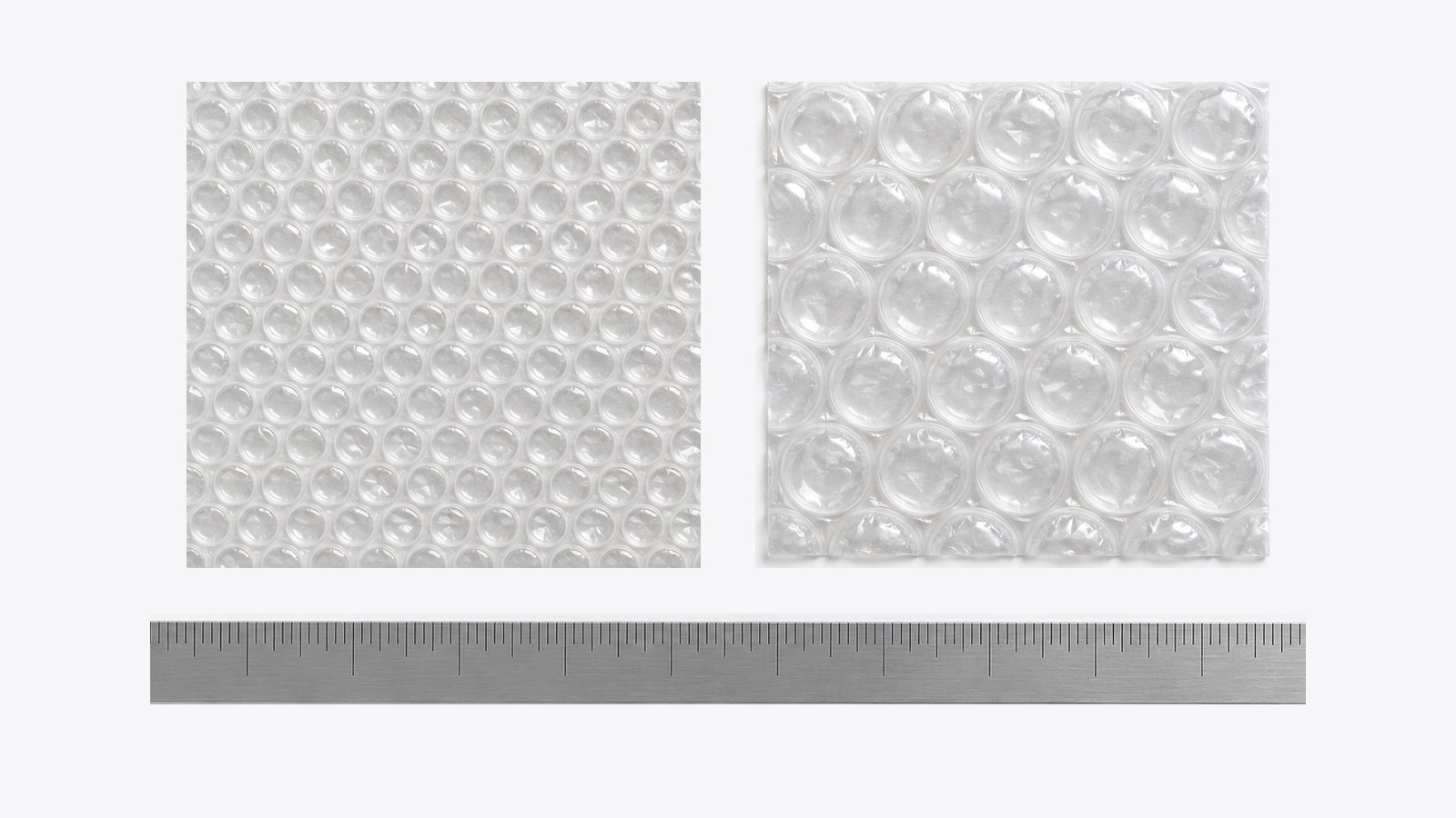 Small bubble wrap (about 10 mm bubbles) next to large bubble wrap (about 20 mm bubbles) on a ruler